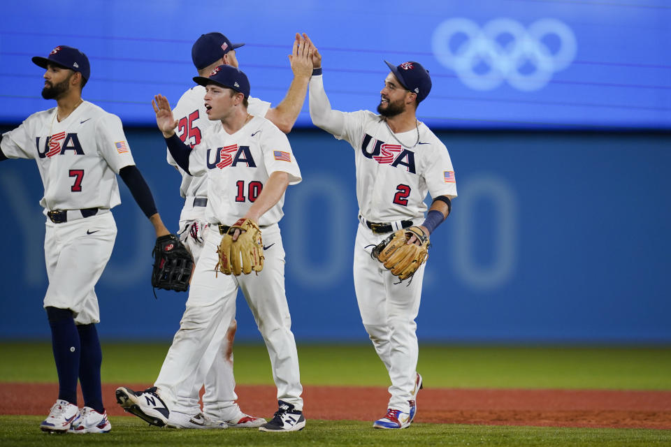 United States' Eddy Alvarez, right, and teammates celebrate after a semi-final baseball game against South Korea at the 2020 Summer Olympics, Thursday, Aug. 5, 2021, in Yokohama, Japan. The United States won 7-2. (AP Photo/Sue Ogrocki)