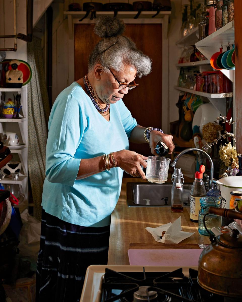 Jessica B. Harris measures out olive oil for her sesame-honey-ginger dressing