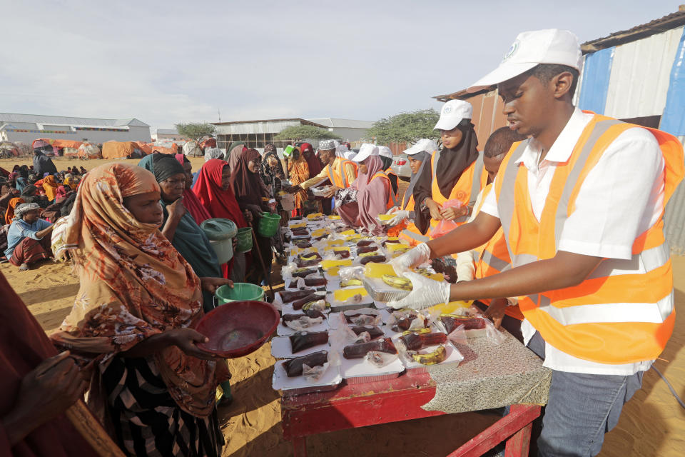 Local NGO prepare Iftar food for people at an internally displaced people camp on the outskirts of Mogadishu, Somalia, Friday, March 24, 2023. This year's holy month of Ramadan coincides with the longest drought on record in Somalia. (AP Photo/Farah Abdi Warsameh)