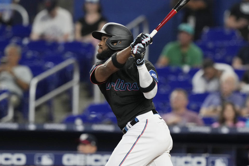 Miami Marlins Bryan De La Cruz (14) hits a home run during the second inning of a baseball game against the Washington Nationals, Thursday, May 18, 2023, in Miami. (AP Photo/Marta Lavandier)