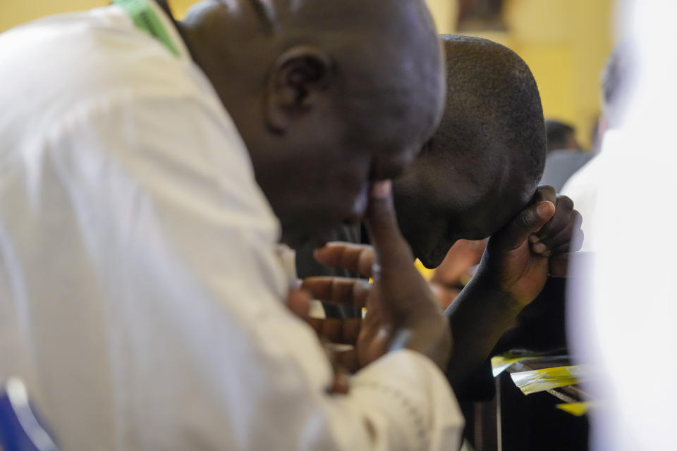 People pray before the arrival of Pope Francis for a meeting with priests, deacons, consecrated people and seminarians at the Cathedral of Saint Theresa in Juba, South Sudan, Saturday, Feb. 4, 2023. Francis is in South Sudan on the second leg of a six-day trip that started in Congo, hoping to bring comfort and encouragement to two countries that have been riven by poverty, conflicts and what he calls a "colonialist mentality" that has exploited Africa for centuries. (AP Photo/Gregorio Borgia)
