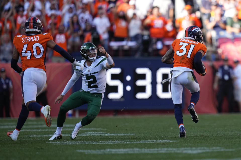 Denver Broncos free safety Justin Simmons (31) intercepts a throw by New York Jets quarterback Zach Wilson (2) during the second half of an NFL football game, Sunday, Sept. 26, 2021, in Denver. (AP Photo/Jack Dempsey)