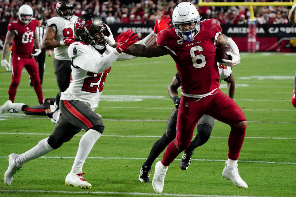 Arizona Cardinals running back James Conner (6) runs in for a touchdown as Tampa Bay Buccaneers safety Logan Ryan defends during the second half of an NFL football game, Sunday, Dec. 25, 2022, in Glendale, Ariz. (AP Photo/Darryl Webb)