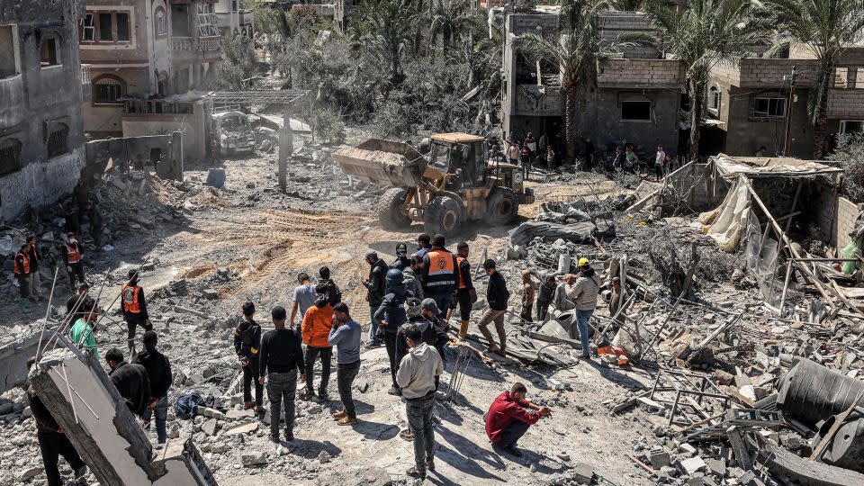 Rescuers inspect the rubble of a building that collapsed following an Israeli air strike in the Rafah refugee camp in the southern Gaza Strip on March 20, 2024. - Said Khatib/AFP/Getty Images