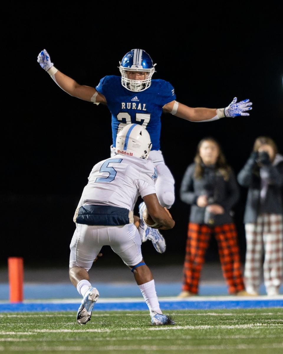 Washburn Rural Jaren Heim (27) leaps before tackling Wichita East quarterback Daeonte’ Mitchell (5) Friday, Nov. 10, 2023, at Washburn Rural High School.