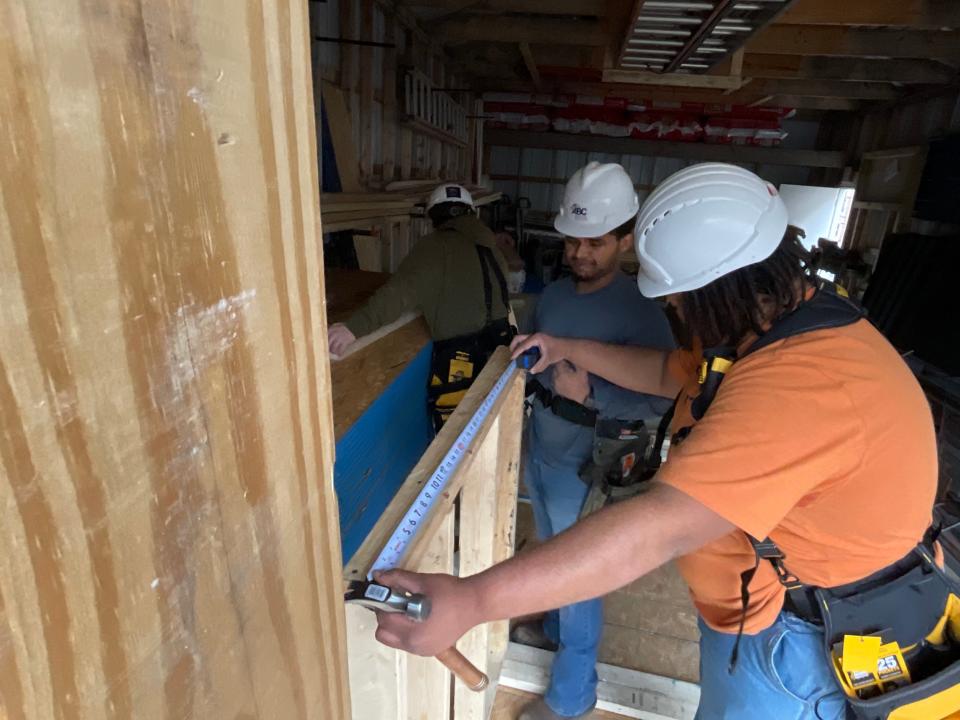 Jayshaun Baity and Deven Bounds, students in the ABC Construction Prep Academy in Marion, work on a storage building. Both are among the first beneficiaries of Indiana’s new Career Scholarship Accounts, which paid for the tools they’re using.