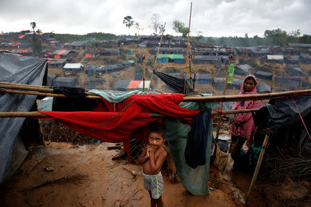 A Rohingya refugee child waits in a camp in Cox's Bazar, Bangladesh, September 17, 2017. REUTERS/Cathal McNaughton