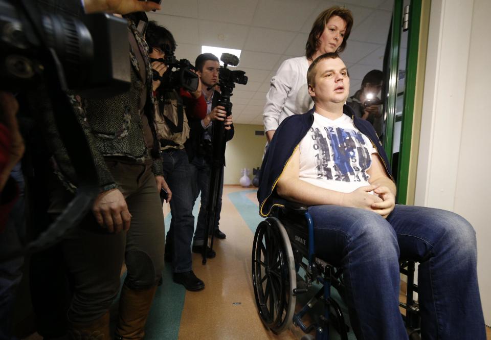 FILE - In this Thursday, Feb. 6, 2014 file photo, Ukrainian opposition activist Dmytro Bulatov is seen in a hospital after a press conference in Vilnius, Lithuania. Protest leader Dmytro Bulatov after being beaten and having a part of his ear cut off during the protests was appointed Youth and Sports Minister during a session in the Ukrainian parliament in Kiev, Ukraine, Thursday, Feb. 27, 2014. Top figures in Ukraine's three-month protest are taking up powerful posts in the new Cabinet, underscoring the powerful and unpredictable force of the revolt. But while few doubt the leaders' resolve, the nominations have raised questions about their skills and expertise — especially given the enormous challenges the new government faces. (AP Photo/Mindaugas Kulbis)