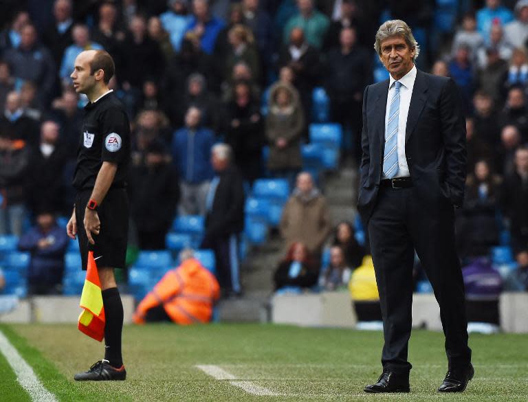 Manchester City's Chilean manager Manuel Pellegrini (R) looks on during their English Premier League football match against Aston Villa in Manchester, England, on April 25, 2015