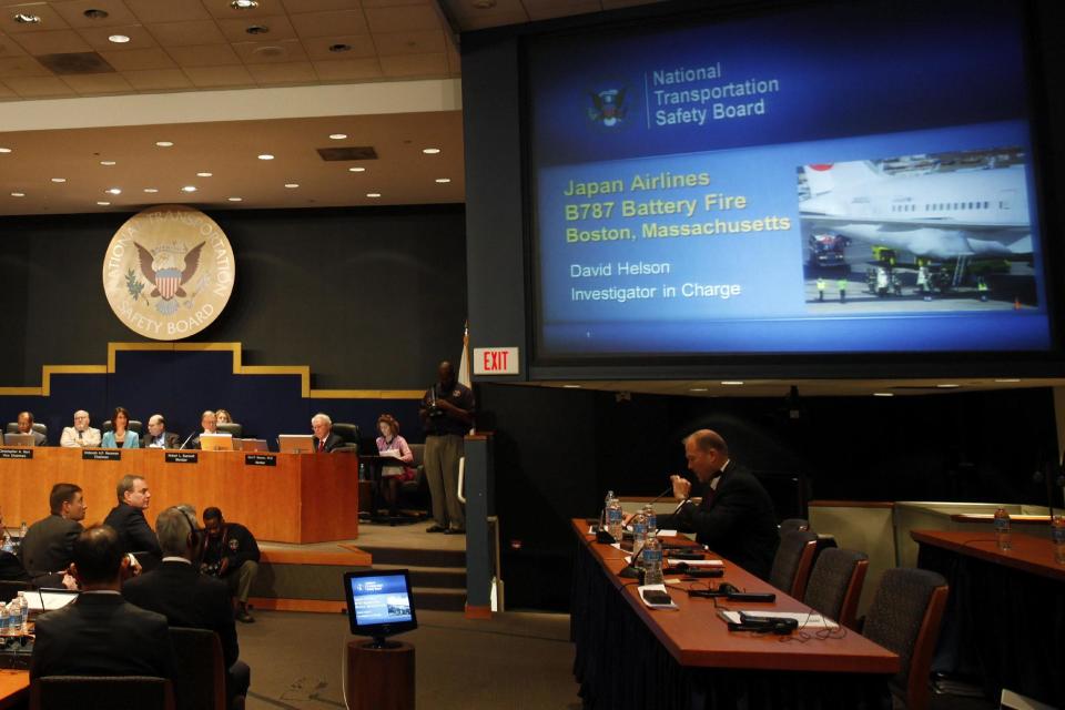 David Helson, National Transportation Safety Board (NTSB) Investigator in Charge, seated right, speaks during a hearing investigating a battery fire aboard a Boeing 787, Tuesday, April 23, 2013, at the NTSB in Washington. Also pictured are Boeing Commercial Airplanes Vice President and Chief Project Engineer Mike Sinnett, seated second from left, and NTSB Chairman Deborah Hersman, top third from left. (AP Photo/Charles Dharapak)