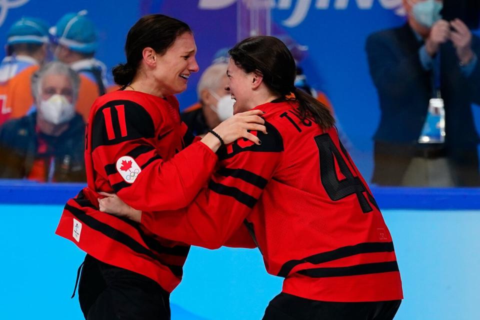 Nova Scotia's Jill Saulnier (11) and Blayre Turnbull (40) celebrate after Canada beat the United States to win the women's gold medal hockey game at the 2022 Winter Olympics on Thursday, Feb. 17, 2022, in Beijing.