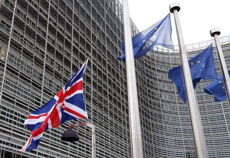 A Union Jack flag is raised next to European Union flags ahead of a visit from Britain's Prime Minister David Cameron at the EU Commission headquarters in Brussels, Belgium, January 29, 2016. REUTERS/Francois Lenoir