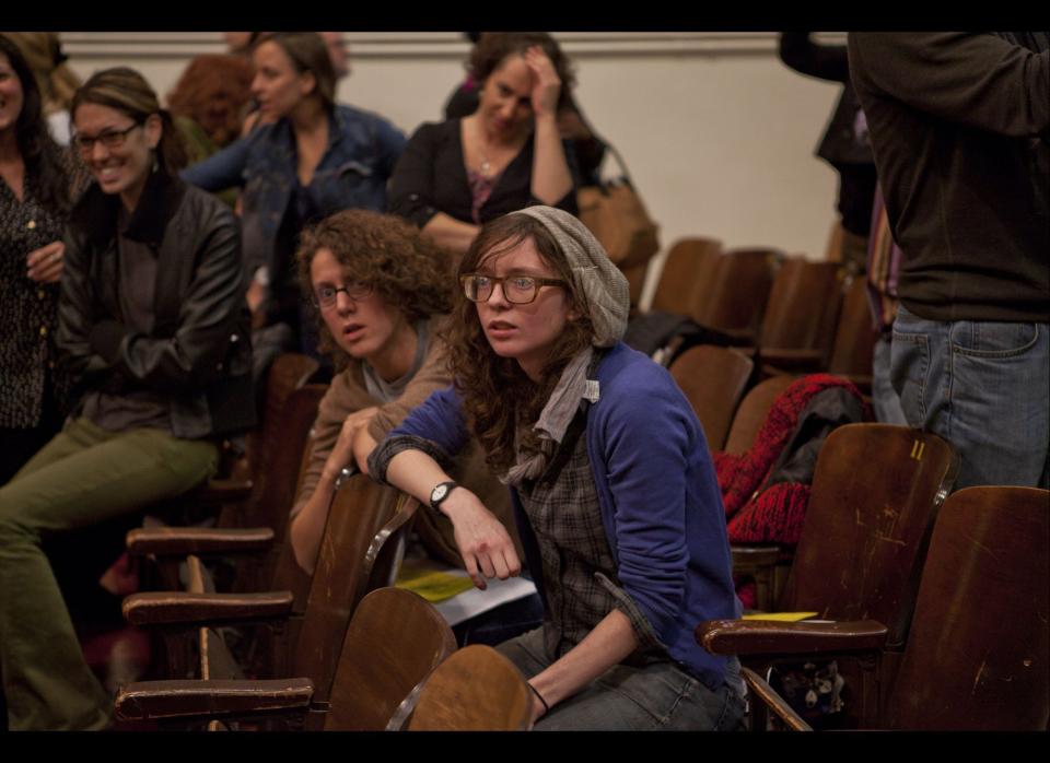 Supporters of Occupy Wall Street listen to another member speak up as a large group occupied the Mayor's Panel for Educational Policy meeting with Chancellor Walcott on Tuesday, October 26, 2011. (Myra Iqbal, AOL)