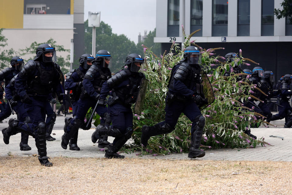 French riot police run amid clashes with protesters during a march in tribute to Nahel, a 17-year-old teenager killed by a French police officer during a traffic stop, in Nanterre on June 29, 2023.<span class="copyright">Sarah Meyssonnier—Reuters</span>
