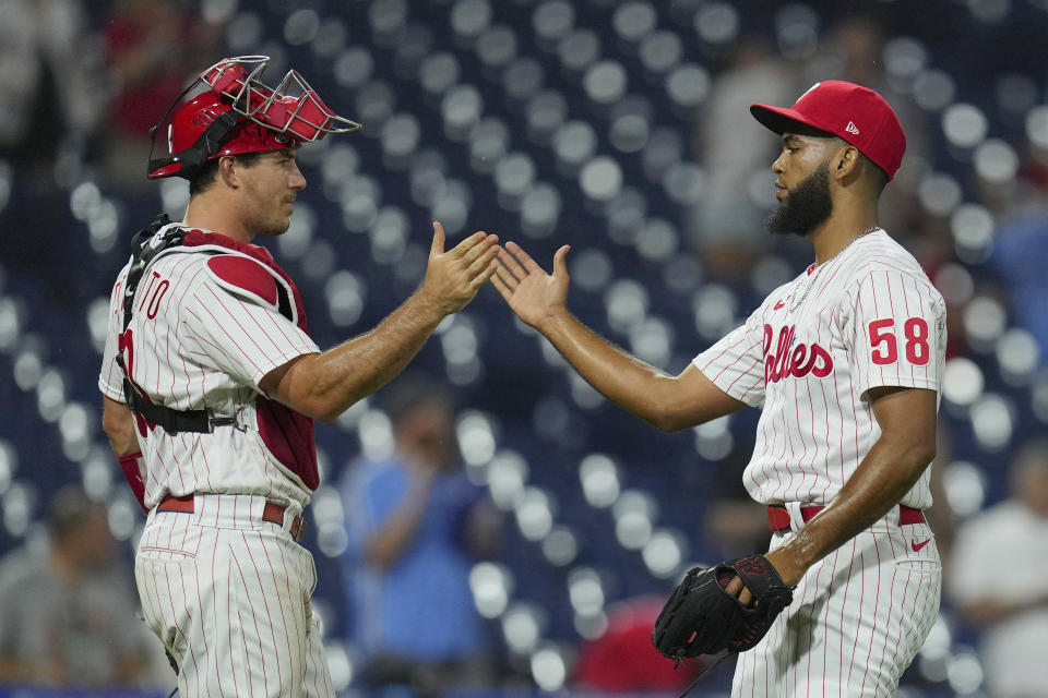 Catcher J.T. Realmuto (10) of the Philadelphia Phillies celebrates with Seranthony Dominguez (58) after a win over the Marlins on Tuesday. (Photo by Mitchell Leff/Getty Images)