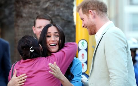 Harry and Meghan meet wellwishers outside the District Six museum - Credit: Reuters