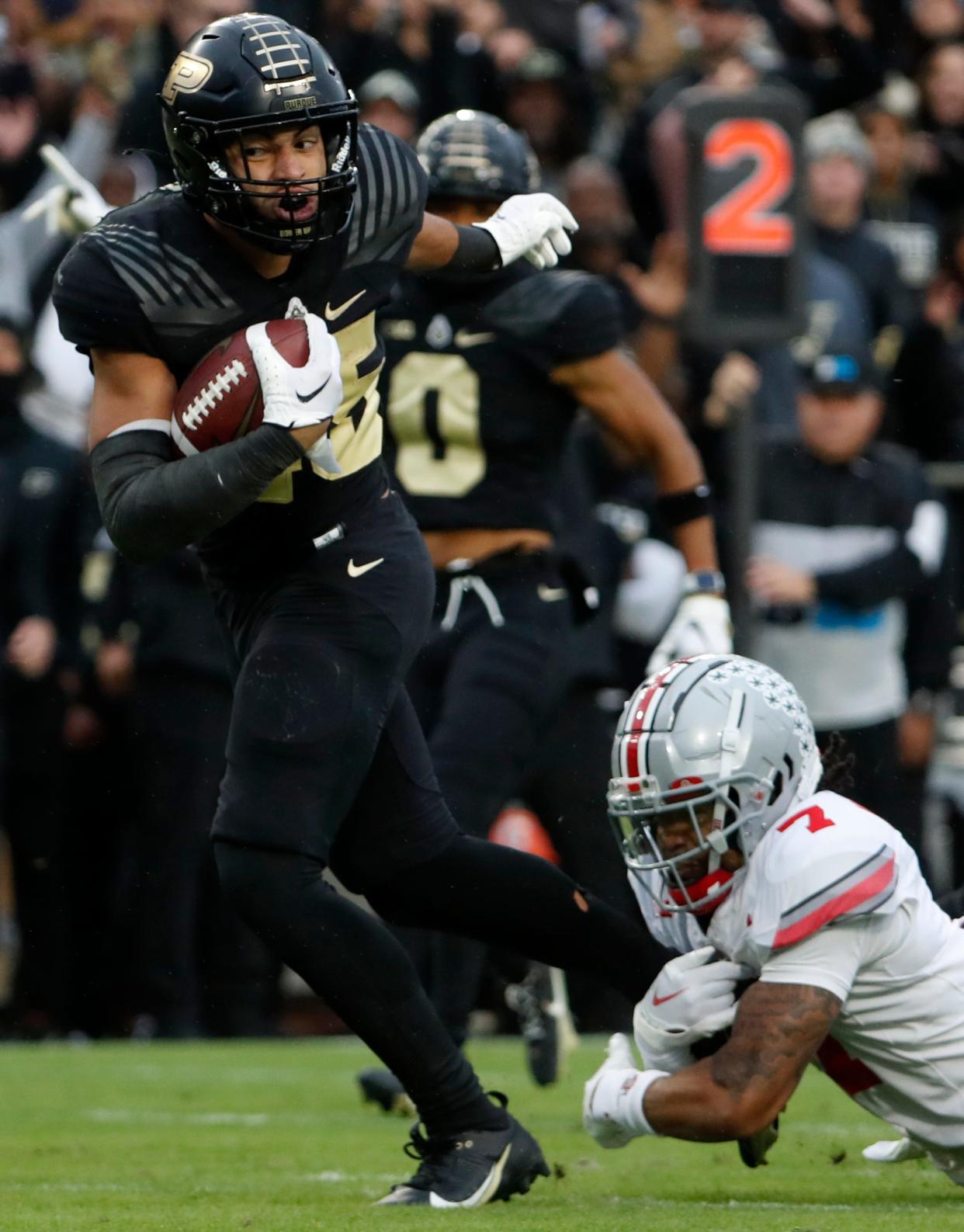 Purdue Boilermakers running back Devin Mockobee (45) breaks the tackle of Ohio State Buckeyes cornerback Jordan Hancock (7) during the NCAA football game, Saturday, Oct. 14, 2023, at Ross-Ade Stadium in West Lafayette, Ind. Ohio State Buckeyes won 41-7.