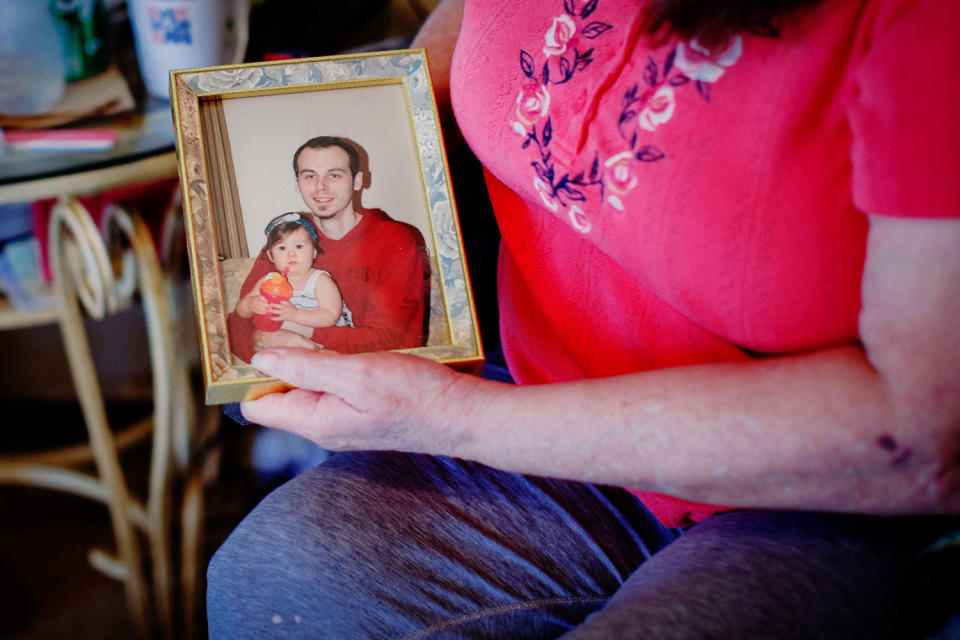 Cheryl Brock holds a photo of her son, James Aaron Moran. (Ashleigh Coleman for NBC News)