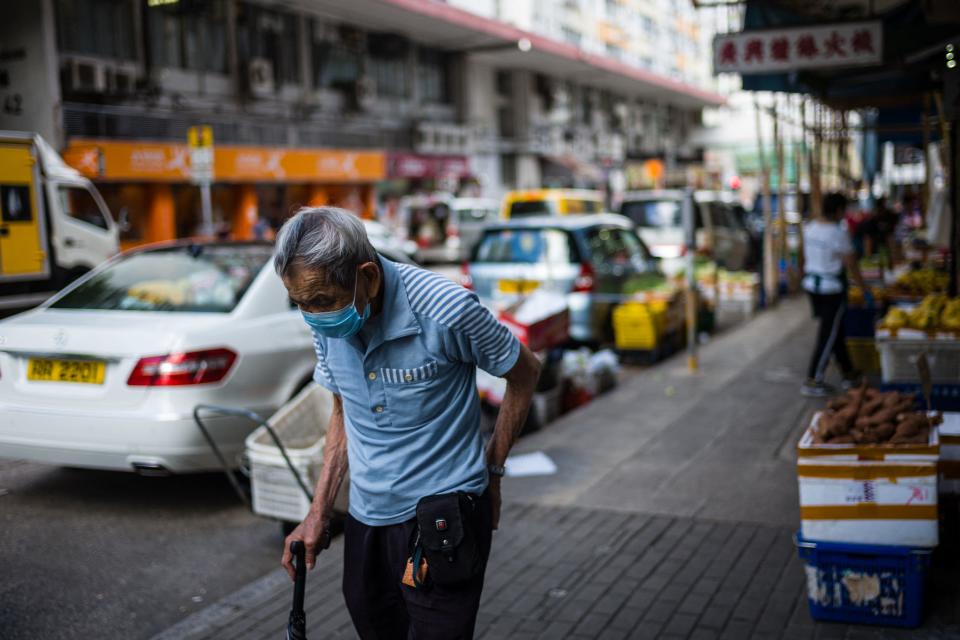 An elderly man walks on a street in Hong Kong on June 16, 2021. (Photo by Anthony WALLACE / AFP) (Photo by ANTHONY WALLACE/AFP via Getty Images)