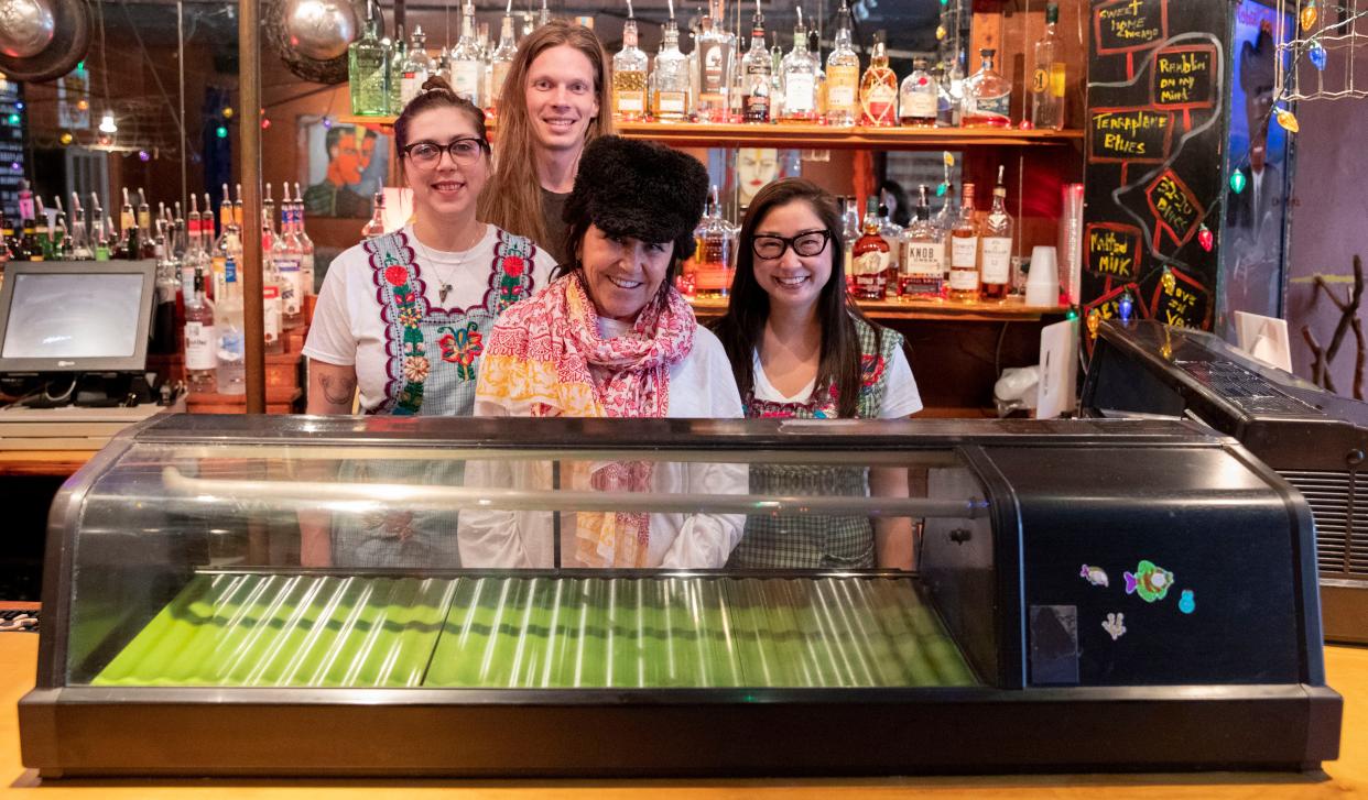 Ben Pierce, back, Shay Widmer, left, Karen Carrier, center, and Mindy Son, right, stand behind the counter Friday, March 11, 2022, at Bar DKDC in Memphis. Dō Sushi will host a one day pop-up at the bar on Wednesday, March 23. Carrier developed the concept, and Pierce, Son and Widmer will help roll sushi during the pop-up.