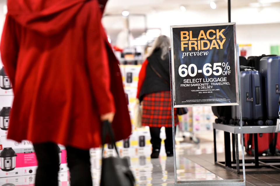 Shoppers walk past a placard that states "Black Friday preview" at a Macy's store as pre-Thanksgiving and Christmas holiday shopping accelerates at the King of Prussia Mall in King of Prussia, Pennsylvania, U.S. November 22, 2019. REUTERS/Mark Makela