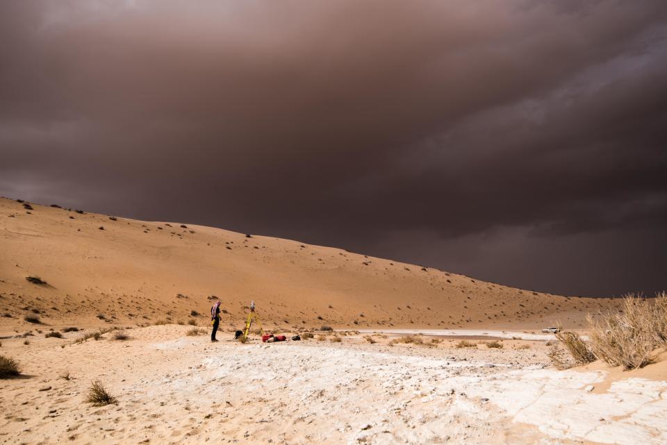 In this undated photo provided by the Palaeodeserts Project in September 2021, a storm arrives during an archaeological excavation of the remains of an ancient lake in northern Saudi Arabia, where ancient humans lived alongside animals such as hippos. (Klint Janulis/Palaeodeserts Project via AP)