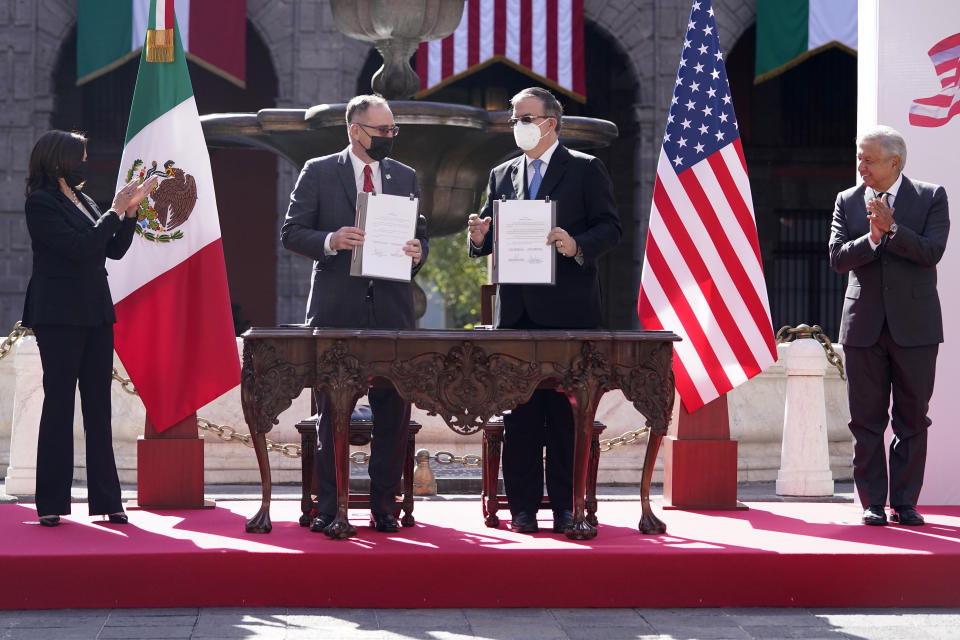 FILE - In this June 8, 2021 file photo, John Creamer, Chargé d'Affaires U.S. Embassy, left center, and Mexico's Foreign Minister Marcelo Ebrard, hold up signed documents as Vice President Kamala Harris, left, and Mexican President Andres Manuel Lopez Obrador, applaud at a signing ceremony at the National Palace in Mexico City. A gathering of leaders from Latin America and the Caribbean in Mexico City on Saturday, Sept. 17, 2021, s the latest sign of Mexico flexing its diplomatic muscle as it looks to assert itself as the new mediator between the region and the United States. (AP Photo/Jacquelyn Martin, File)