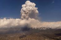 Lava flows around houses following the eruption of a volcano on the Island of La Palma