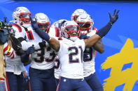 New England Patriots safety Adrian Phillips (21) celebrates after intercepting a pass and running it back for a touchdown during the second half of an NFL football game against the Los Angeles Chargers Sunday, Oct. 31, 2021, in Inglewood, Calif. (AP Photo/John McCoy)