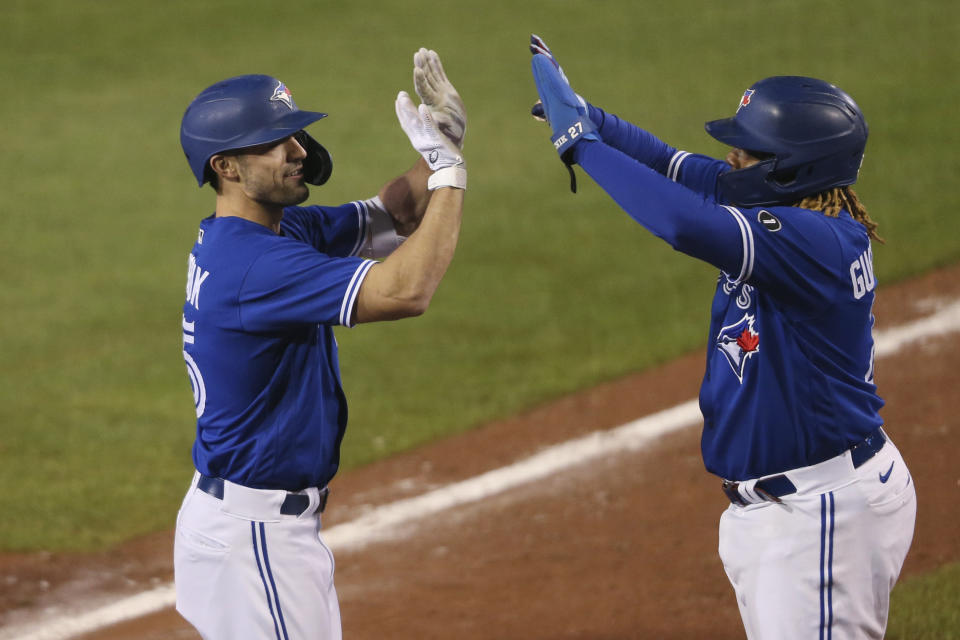 Toronto Blue Jays Randal Grichuk,left, celebrates his three-run home run with Vladimir Guerrero Jr. during the seventh inning of the team's baseball game against the Baltimore Orioles, Saturday, Sept. 26, 2020, in Buffalo, N.Y. (AP Photo/Jeffrey T. Barnes)