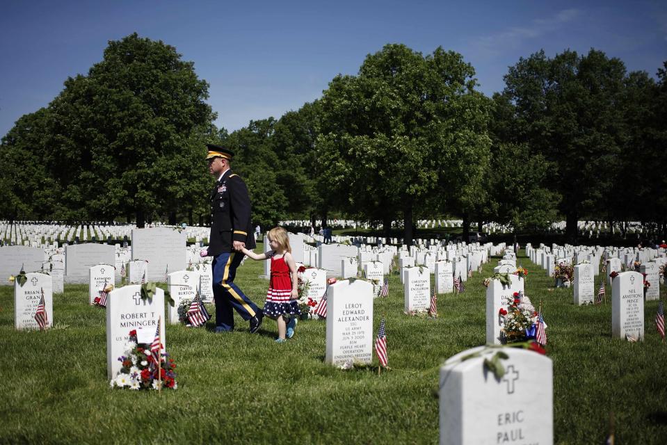 Visitors walk between graves in Section 60, where many casualties of the U.S. wars in Iraq and Afghanistan are buried, on Memorial Day at Arlington National Cemetery in Arlington, Virginia May 26, 2014. President Obama marked Memorial Day and the 150th anniversary of the cemetery Monday by laying a wreath to honor the soldiers buried there since the Civil War. (REUTERS/Jonathan Ernst)