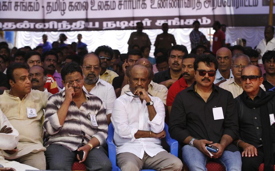Indian Tamil movie stars, including superstar Rajnikanth, center, sit during a day long fast in Chennai, India, Tuesday, April 2, 2013 demanding probe into alleged wartime abuses by Sri Lanka. The stars are fasting for a day to protest what they say is the mistreatment of ethnic Tamils in neighboring Sri Lanka and to demand an international probe into alleged wartime abuses there. A U.N. investigation into the final months of the war indicated that the ethnic Sinhalese-dominated government might have killed as many as 40,000 Tamil civilians. (AP Photo/Arun Sankar K)