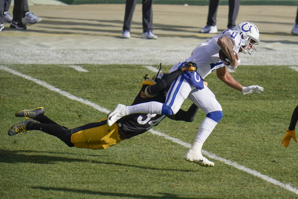 Indianapolis Colts wide receiver Michael Pittman, right, drags Pittsburgh Steelers strong safety Terrell Edmunds, left, after making a catch during the first half of an NFL football game, Sunday, Dec. 27, 2020, in Pittsburgh. (AP Photo/Gene J. Puskar)