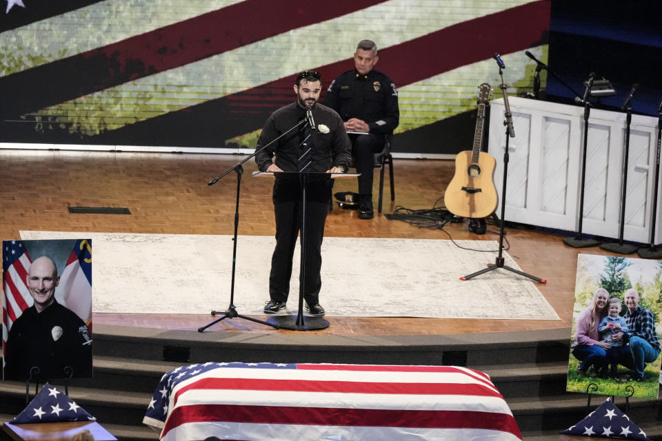 Pastor Justin Wallace gives a eulogy during a memorial service for Officer Joshua Eyer, Friday, May 3, 2024, in Charlotte, N.C. Police in North Carolina say a shootout that killed Eyer and wounded and killed other officers began as officers approached a home to serve a felony warrant on Monday. (AP Photo/Chris Carlson)