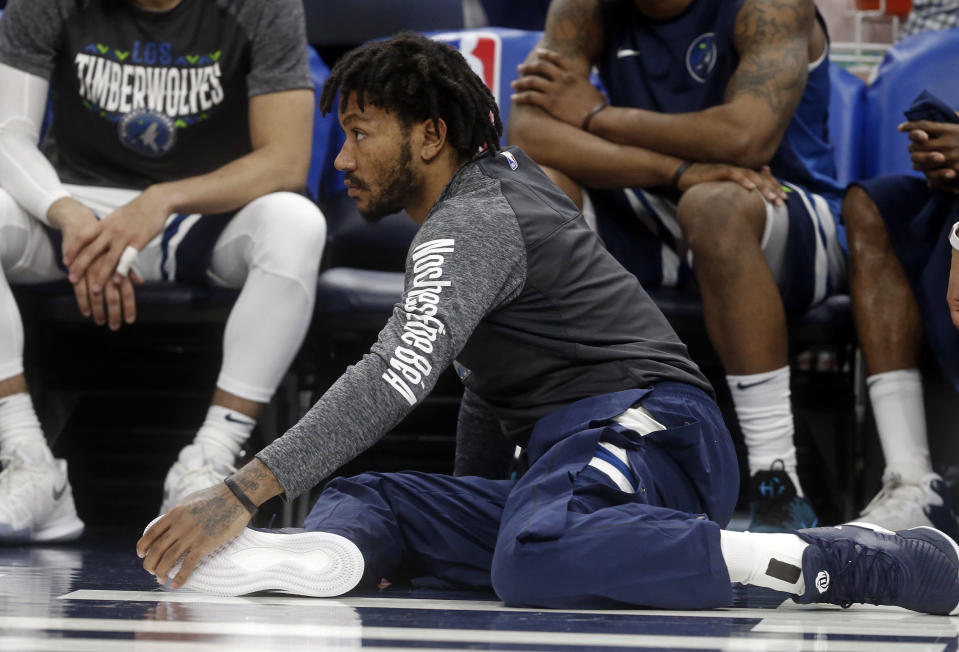 Newly signed Minnesota Timberwolves’ Derrick Rose watches his new team in the second half of an NBA basketball game against the Boston Celtics Thursday, March 8, 2018, in St. Paul, Minn. The Celtics won 117-109. (AP Photo/Jim Mone)