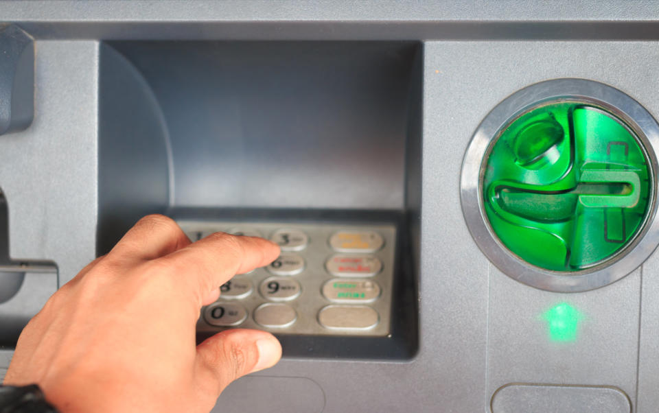 ATM close-up with male hand