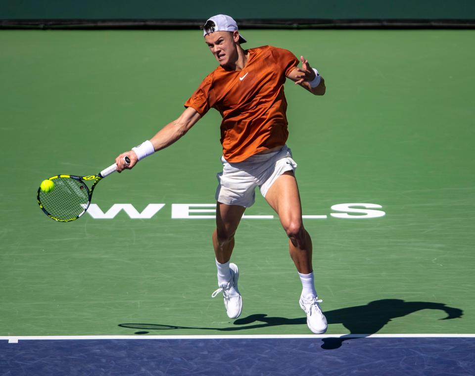 Holger Rune of Denmark takes a shot at Stan Wawrinka of Switzerland during third-round their match at the BNP Paribas Open at the Indian Wells Tennis Garden in Indian Wells, Calif., Monday, March 13, 2023. 