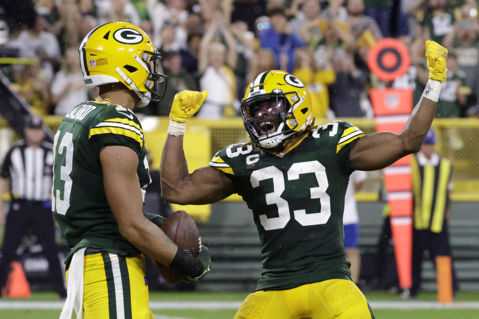 Green Bay Packers wide receiver Allen Lazard (13) celebrates with teammate running back Aaron Jones (33) after catching a 5-yard touchdown pass during the first half of an NFL football game against the Chicago Bears Sunday, Sept. 18, 2022, in Green Bay, Wis. (AP Photo/Mike Roemer)