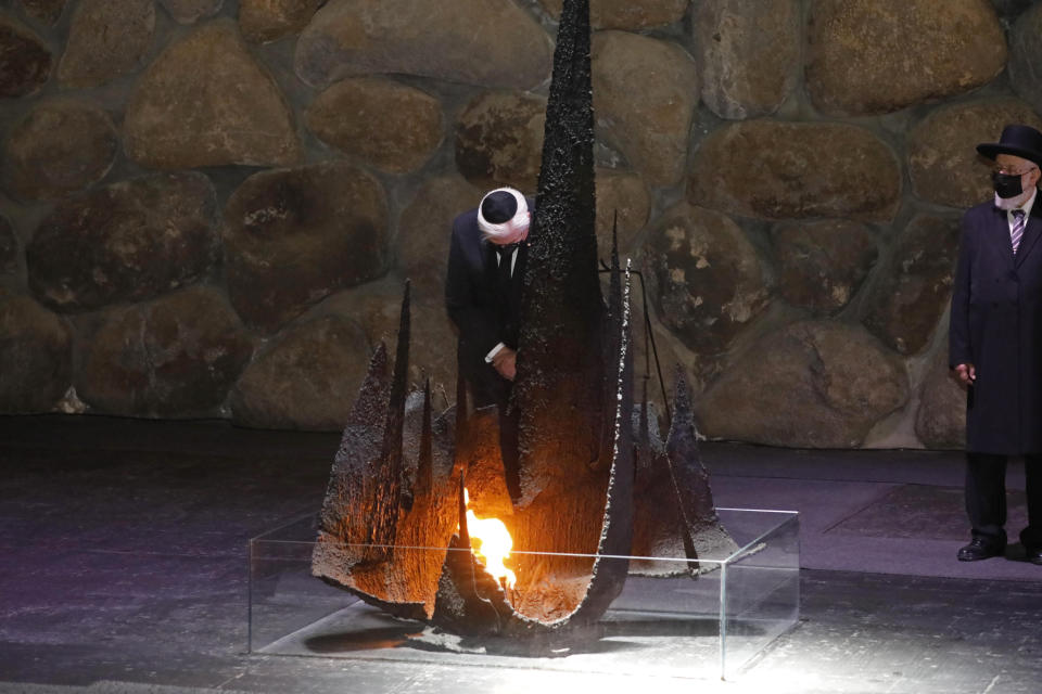 German President Frank-Walter Steinmeier rekindles the Eternal Flame in the Hall of Remembrance at the Yad Vashem Holocaust memorial in Jerusalem, Thursday, July 1, 2021. (AP Photo/Ariel Schalit)