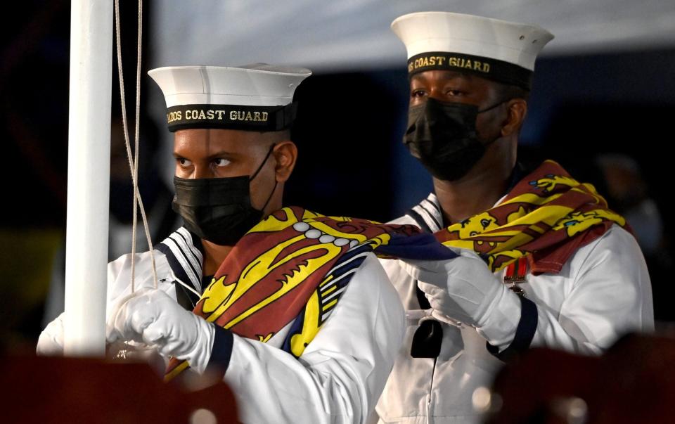 Members of the Barbados Coast Guard remove the Queen's Royal Standard flag - Jeff J Mitchell/Getty Images