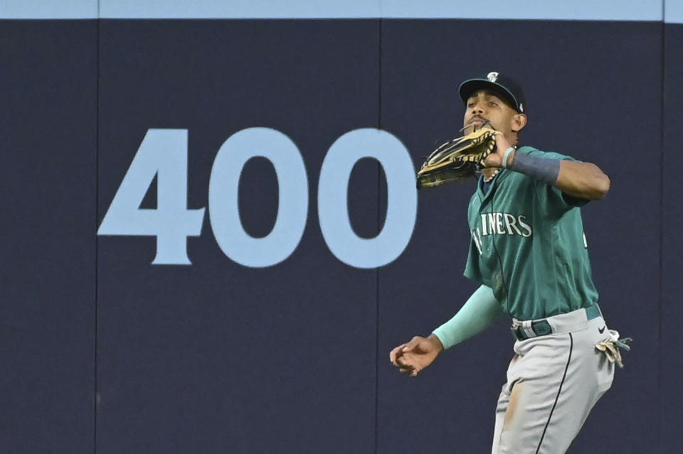 Seattle Mariners center fielder Julio Rodriguez (44) catches a fly ball off the bat of Toronto Blue Jays' Danny Jansen in the fifth inning of a baseball game in Toronto, Saturday, April 29, 2023. (Jon Blacker/The Canadian Press via AP)