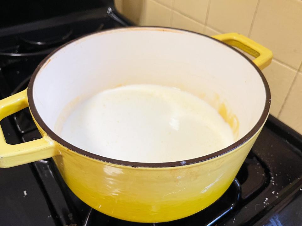 macaroni and cheese sauce in a yellow pot on the stove