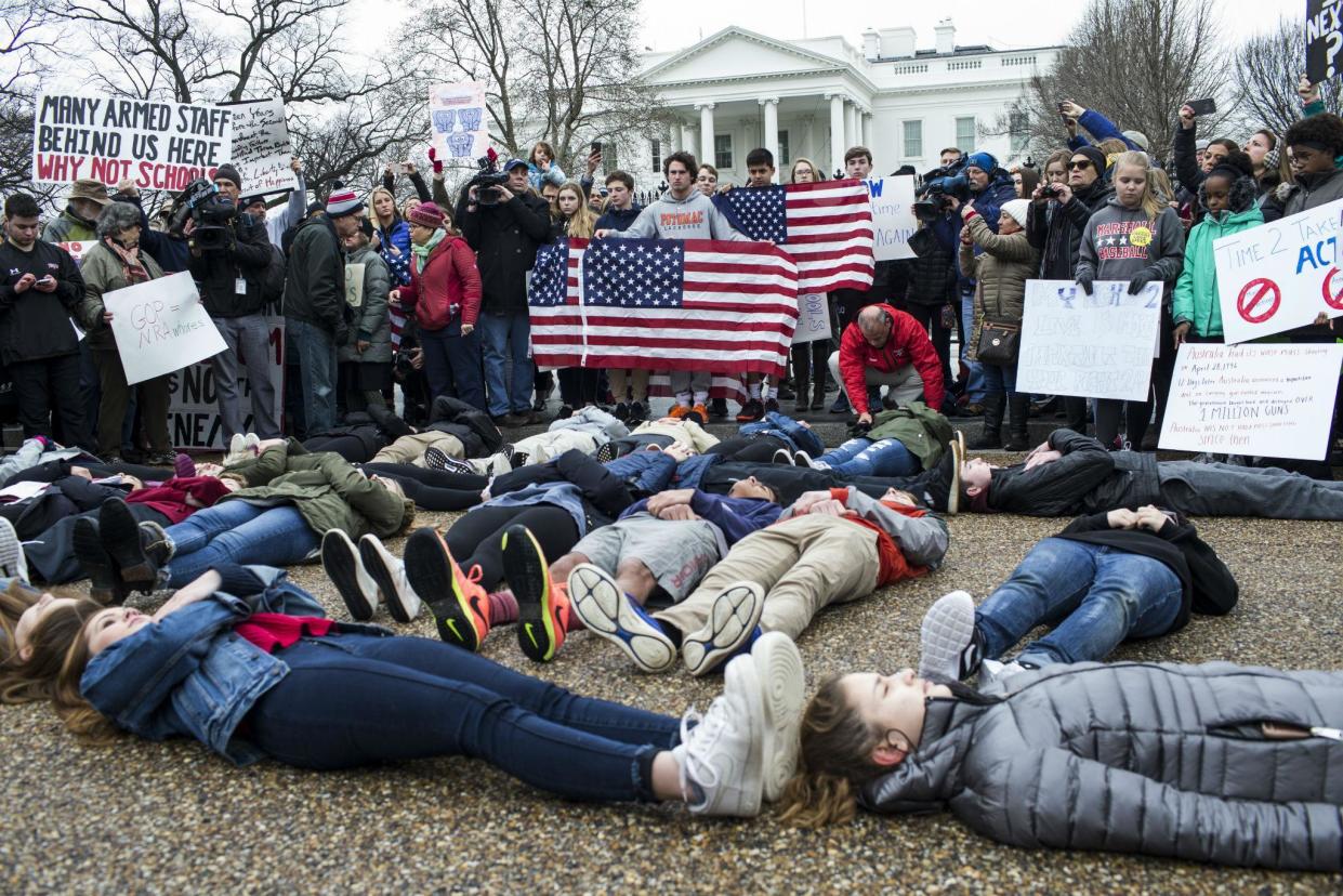 Teenagers stage a 'lie-in' demonstration supporting gun control reform near the White House: Getty Images