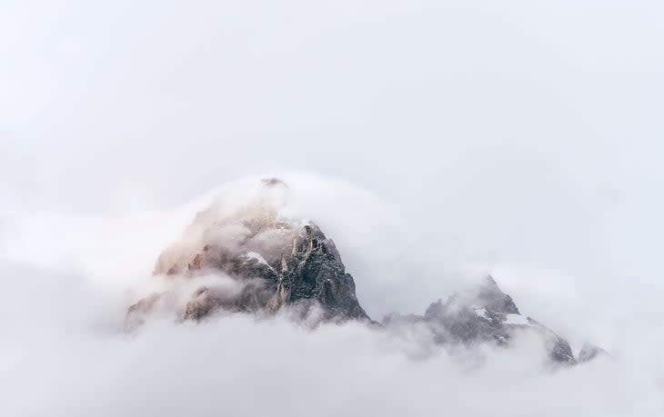 <span class="article__caption">Clouds obscure the summit of the Grand Teton. </span> (Photo: Daniel Vine Garcia / Moment via Getty Images)