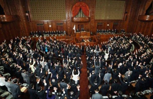 Members of the lower house of parliament raise their hands for banzai cheers at the National Diet in Tokyo as the lower house was dissolved