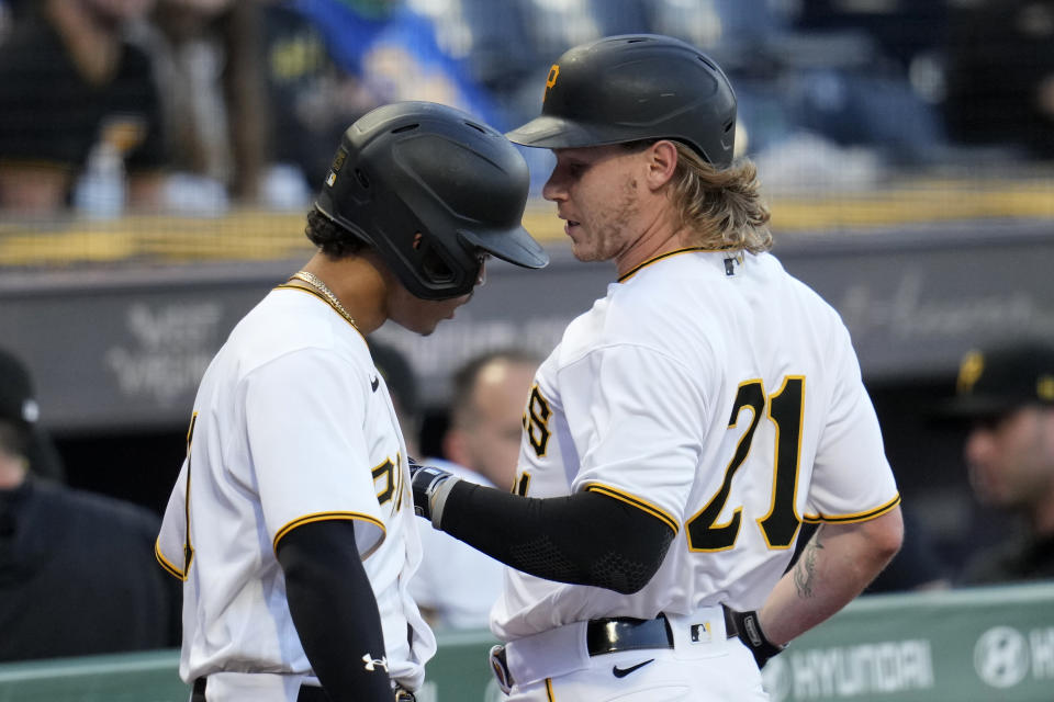 Pittsburgh Pirates' Jack Suwinski, right, returns to the dugout after hitting an RBI sacrifice fly off New York Yankees starting pitcher Gerrit Cole during the first inning of a baseball game in Pittsburgh, Friday, Sept. 15, 2023. Suwinski is wearing No. 21 in honor of Roberto Clemente Day. (AP Photo/Gene J. Puskar)