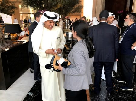 FILE PHOTO: Emirati businessman Mohamed Alabbar, chairman of Dubai-based Emaar Properties, talks to an Israeli radio journalist at the "Peace to Prosperity" conference, in Manama