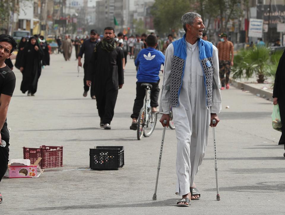 Although shrines are closed due to the new coronavirus, Shiite pilgrims make their way to the shrine of Imam Moussa al-Kadhim, a key Shiite saint, during preparations for the annual commemoration of his death, in Baghdad, Iraq Friday, March 20, 2020. Iraq announced a weeklong curfew to help fight the spread of the virus. For most people, the virus causes only mild or moderate symptoms. For some it can cause more severe illness. (AP Photo/Hadi Mizban)