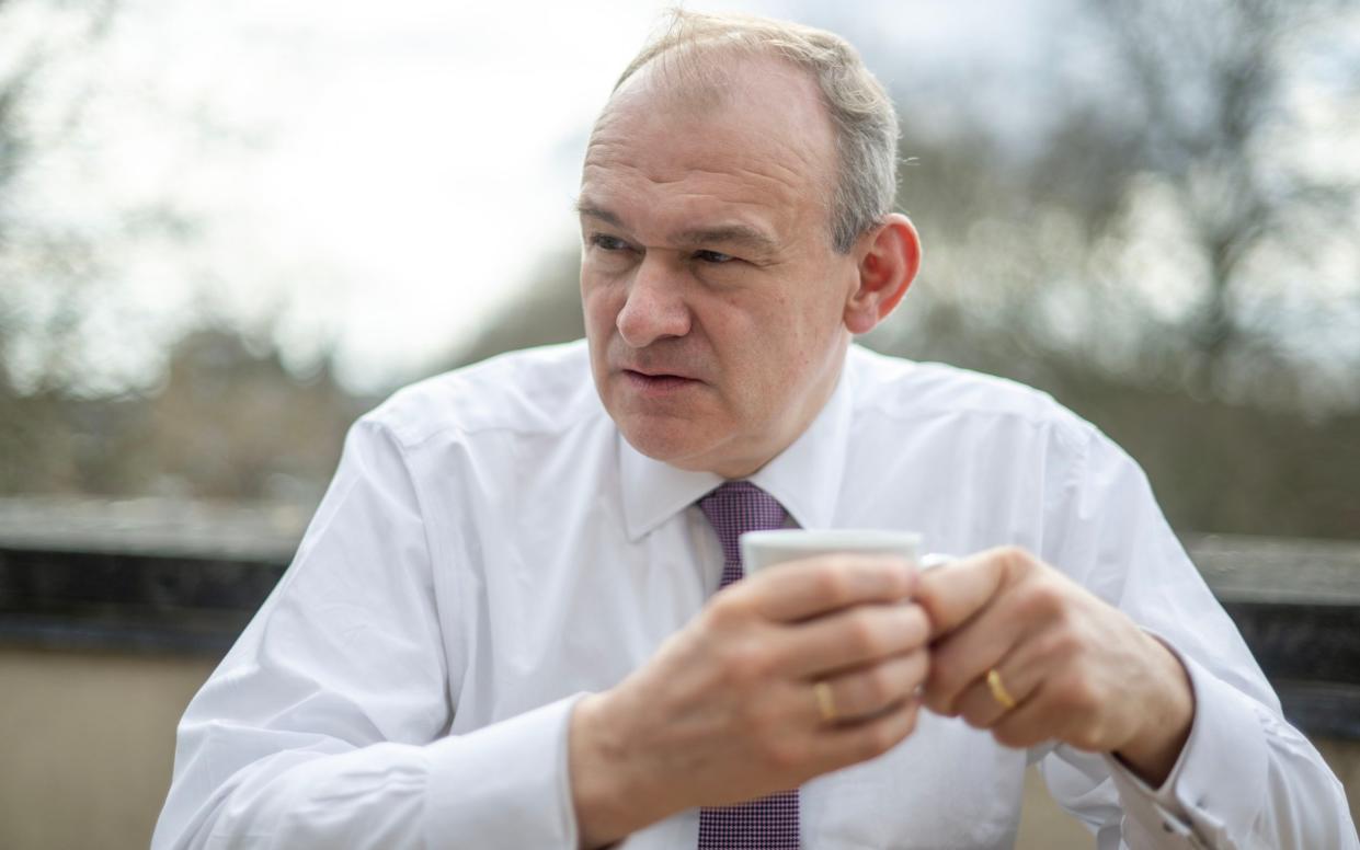 Sir Ed Davey drinking a cup of tea in his shirt sleeves, outside