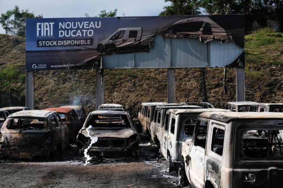 Burnt cars at a car dealer store in Noumea on May 14, 2024